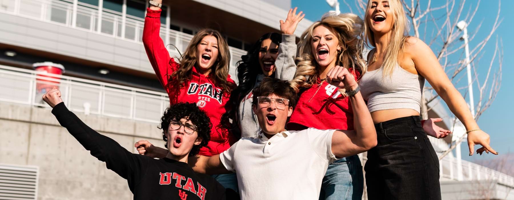 a group of students in front of the University of Utah